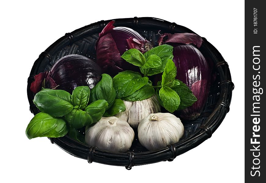 Red onions and garlic in a basket isolated on white