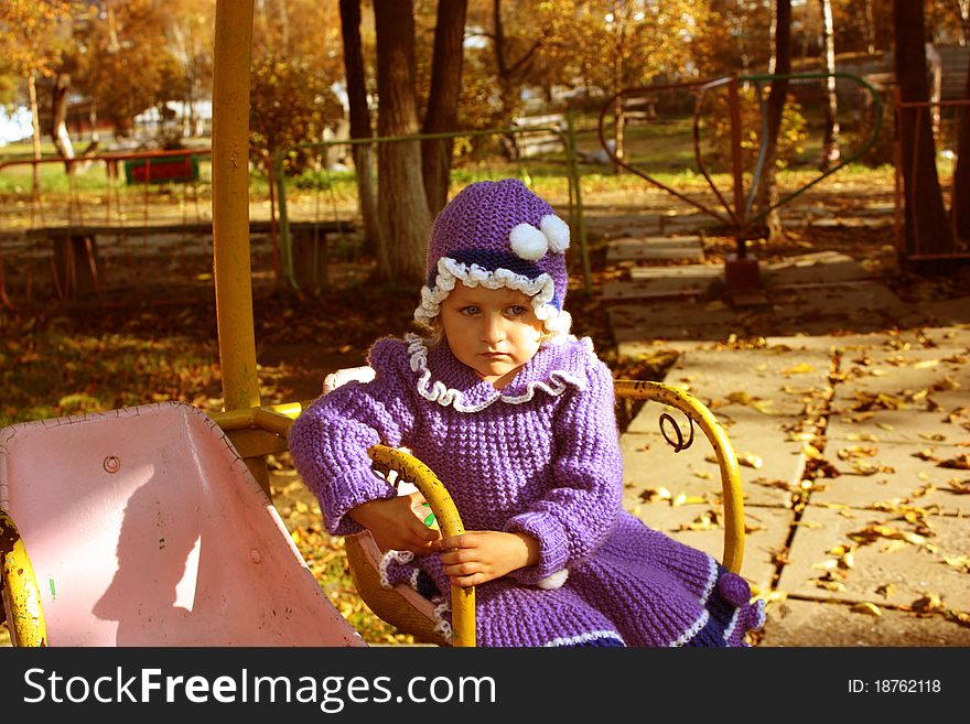 A little sad girl is in autumnal park. A little sad girl is in autumnal park