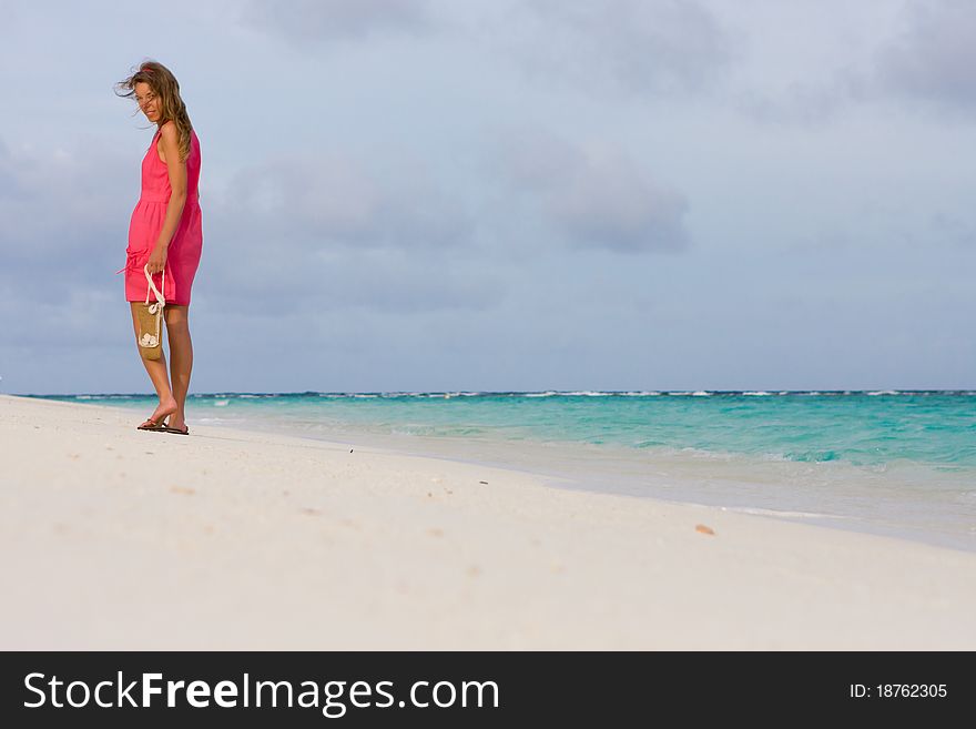 Girl goes for a walk on the coast of tropical island. Girl goes for a walk on the coast of tropical island