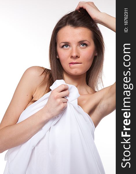 Attractive woman covered in white cloth on white