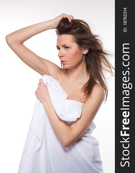 Attractive woman covered in white cloth
