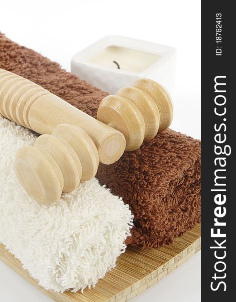 Wooden massager, towels and candle. Wooden massager, towels and candle