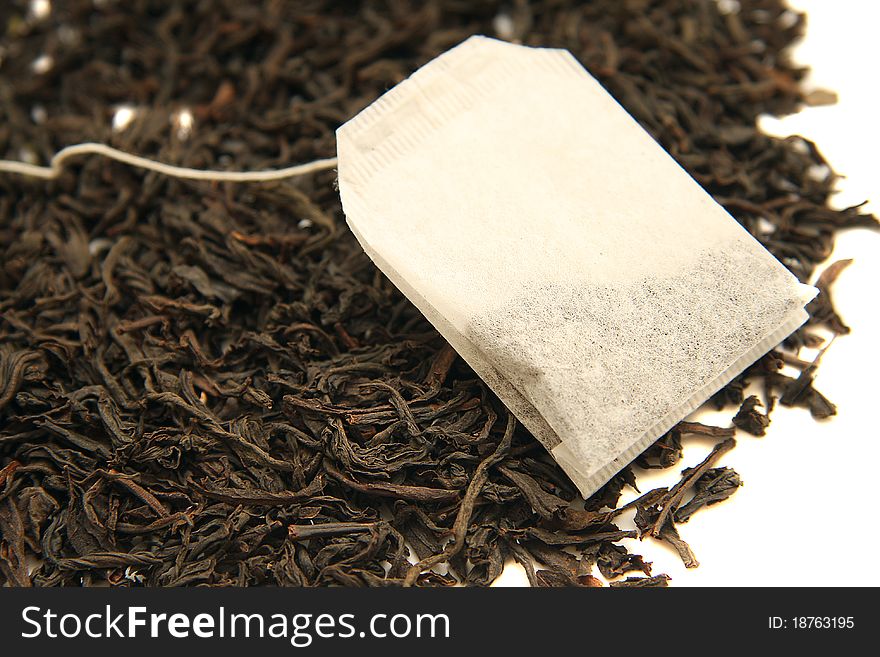 Tea leaves with teabag on white background