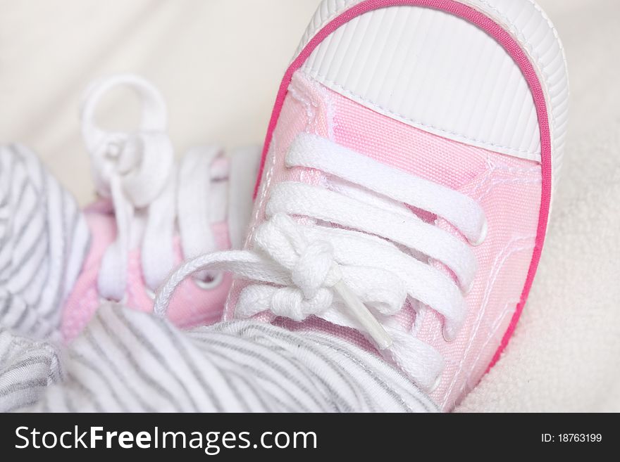 Pink baby shoes close up with macro lens. Pink baby shoes close up with macro lens