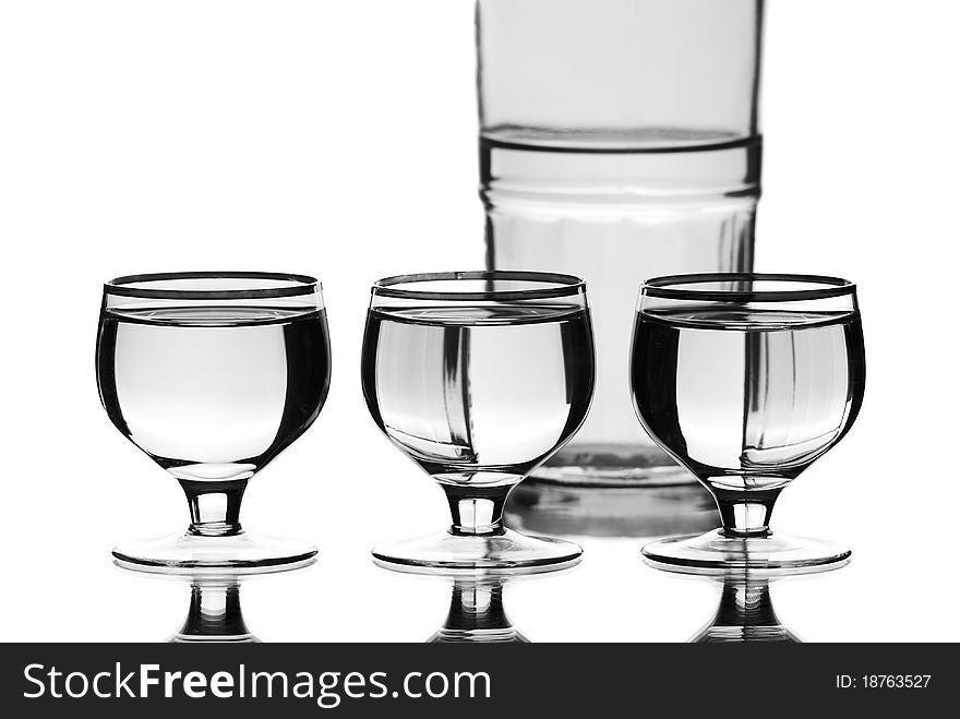 Wine glasses with a bottle. White background. Studio shot. Wine glasses with a bottle. White background. Studio shot.
