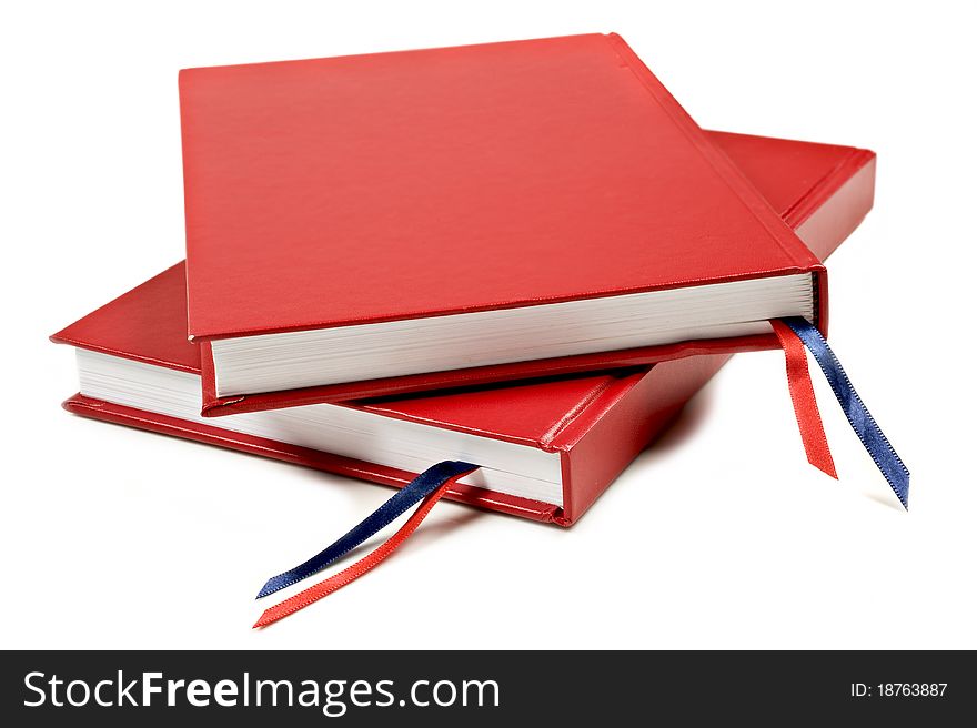 Red notebook on a pure white background with space for text. Red notebook on a pure white background with space for text