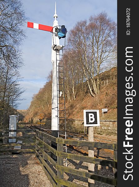 Old traditional railway signal at a points junction in the countryside. Old traditional railway signal at a points junction in the countryside