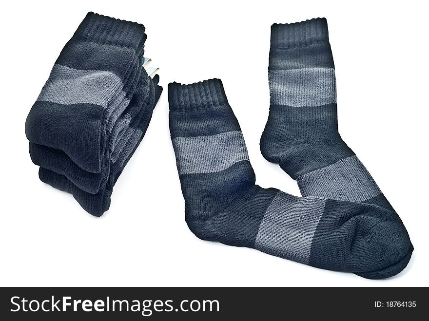 A stack of black socks isolated on a white background.