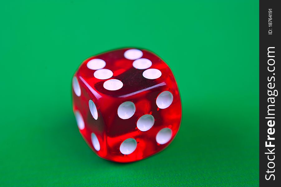 Close-up of  red dices on a green background