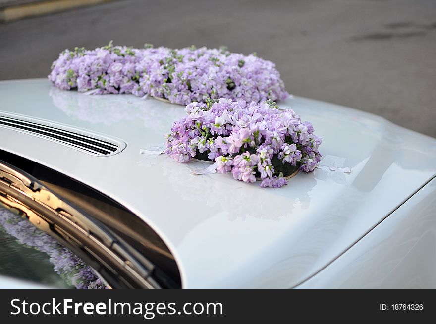 Flowers on a white wedding car. Flowers on a white wedding car