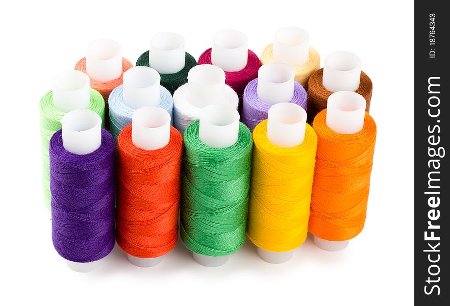 Spools multi-colored threads standing group isolated on a white background