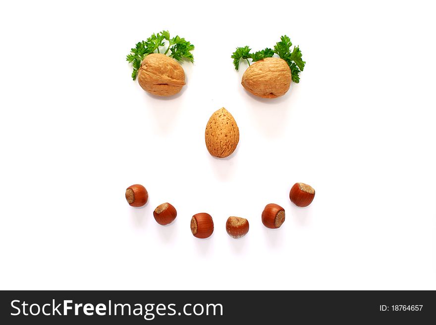 Smiling face is made whith help of nuts