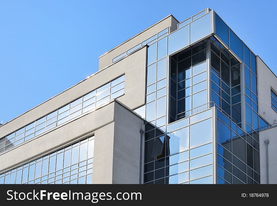 Abstract shot of a business center building against blue sky. Abstract shot of a business center building against blue sky