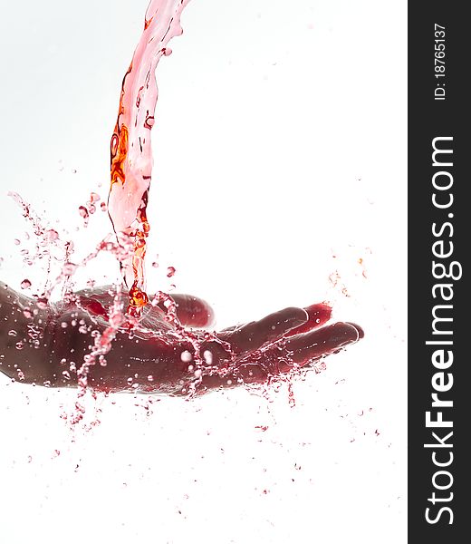 Splashing red water looking like juice or blood on hand. Splashing red water looking like juice or blood on hand