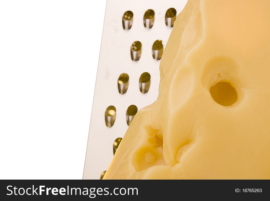 Swiss cheese slice with grater on a white background.