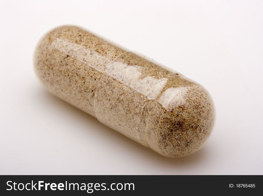 Medical pill against diseases on a white background.