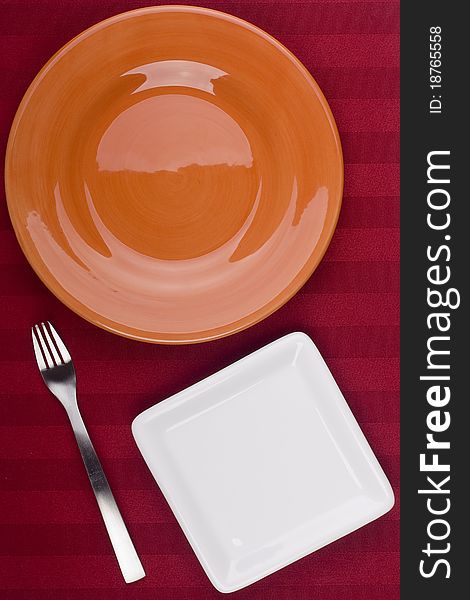 Ceramic plates for table on a red background. Ceramic plates for table on a red background.