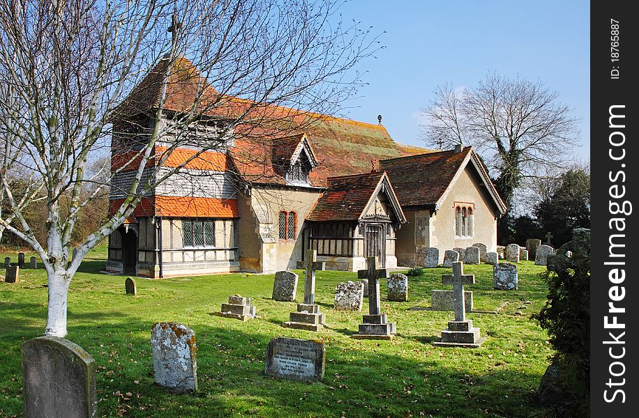 English Village Church and Tower with weathervane viewed from the Graveyard. English Village Church and Tower with weathervane viewed from the Graveyard