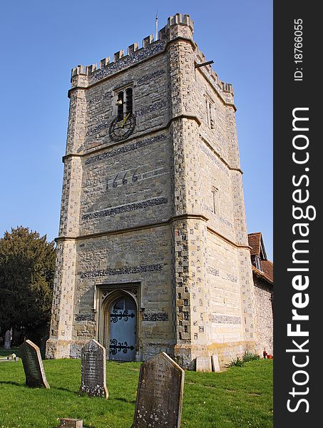 Medieval English Village Church and Tower with Clock viewed from the Graveyard. Medieval English Village Church and Tower with Clock viewed from the Graveyard