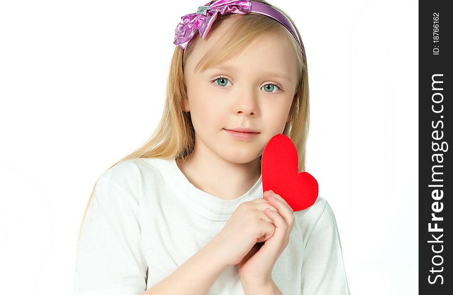 Cute little girl with red heart