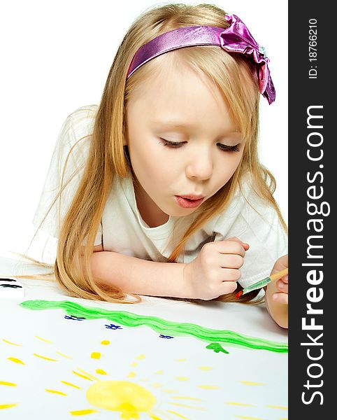 Cute little girl with a brush and paints