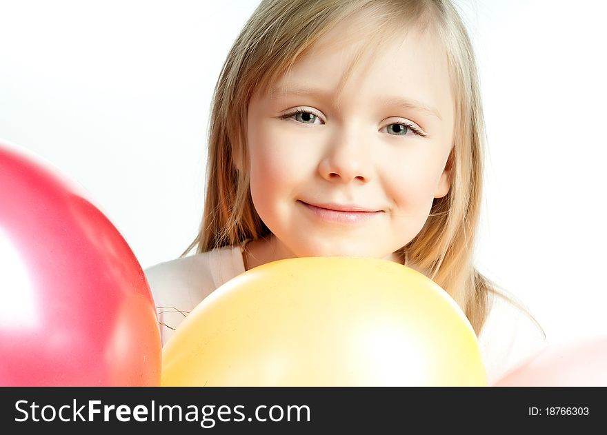 Cute little girl with balloons on white