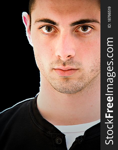 Portrait of a handsome young man, isolated on black