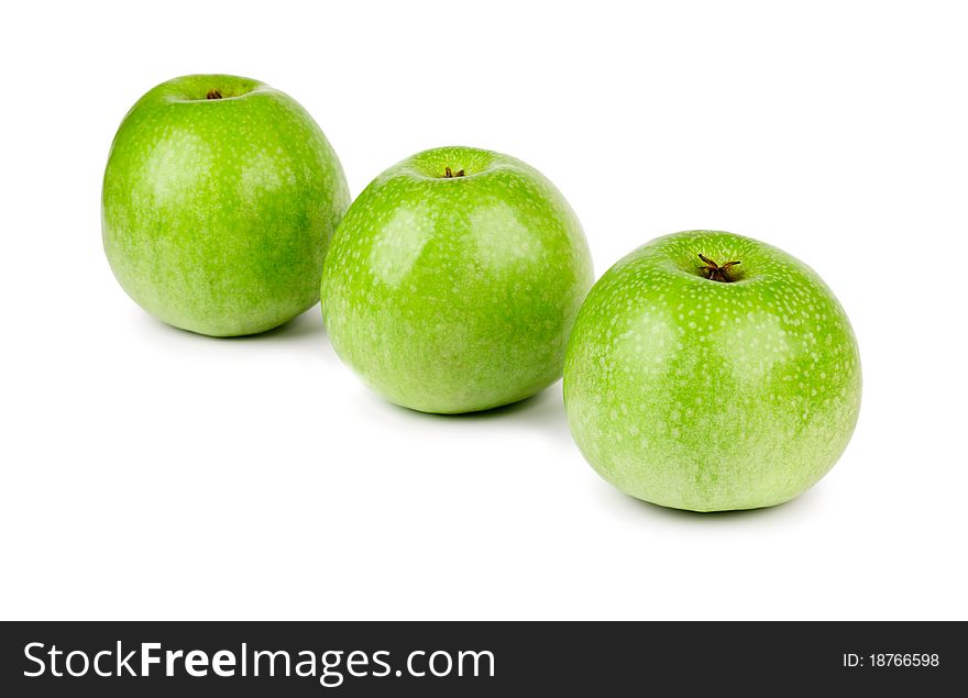 Three ripe and juicy green apples located in a line isolated on a white background. Three ripe and juicy green apples located in a line isolated on a white background