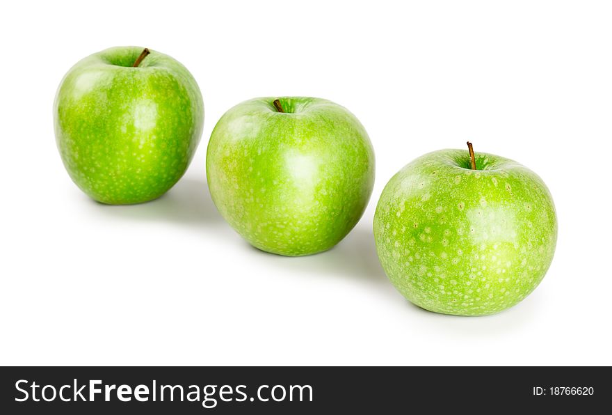 Three ripe and juicy green apples located in a line isolated on a white background. Three ripe and juicy green apples located in a line isolated on a white background