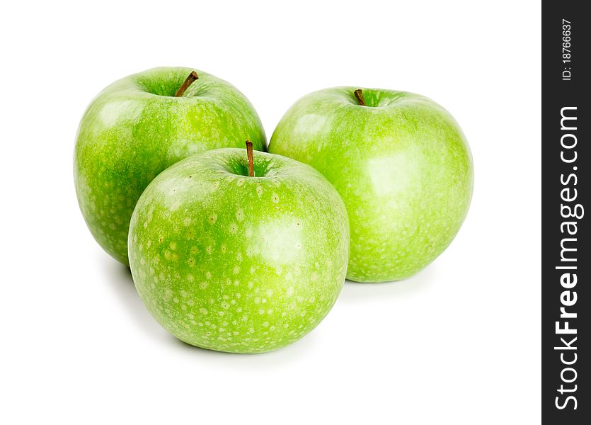 Three ripe and juicy green apples nearby with each other isolated on a white background. Three ripe and juicy green apples nearby with each other isolated on a white background