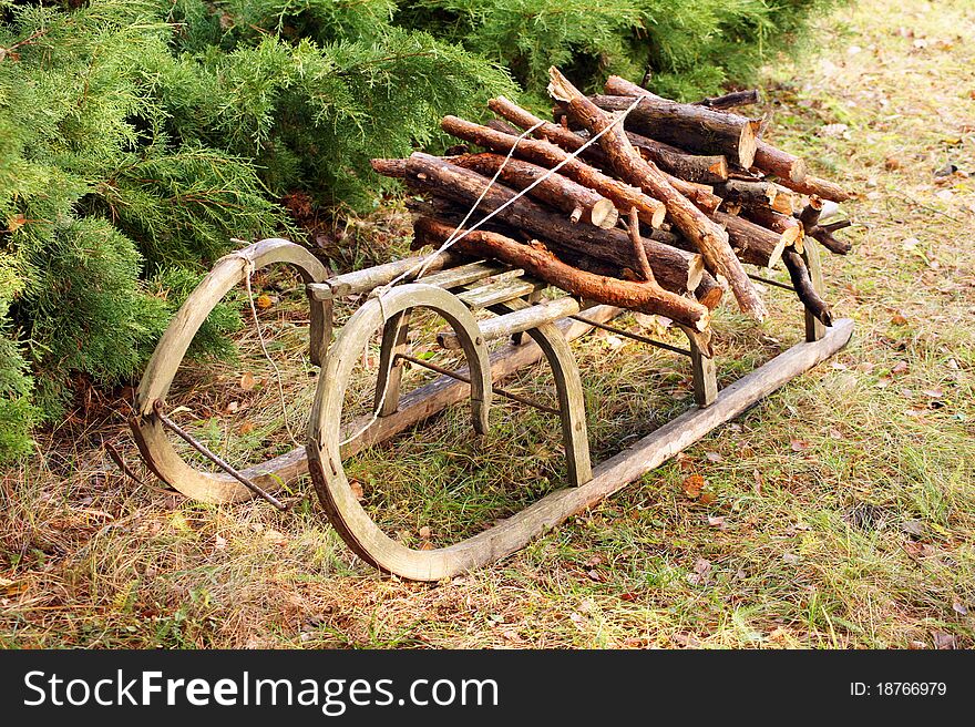 Old wooden snow sled with fire wood