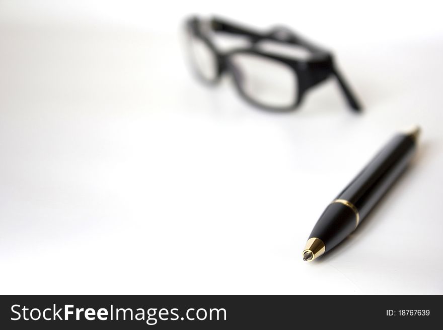 Eyeglasses and pen on isolated white background. Eyeglasses and pen on isolated white background