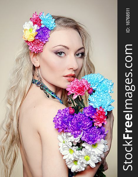 The beautiful young woman with flowers in hair. The beautiful young woman with flowers in hair