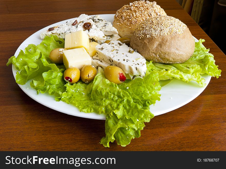 Light mediterranean lunch with cheese, bread and olives