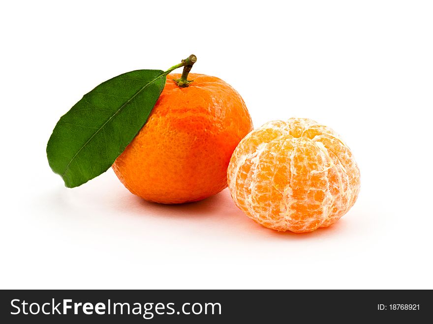 Two tangerines (one skinned) against a white background