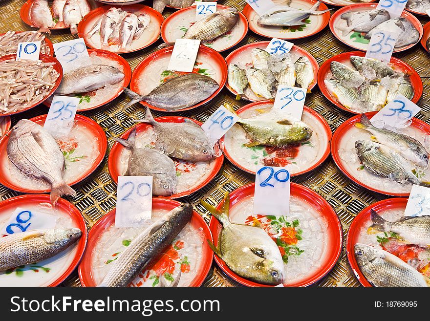 Whole fresh fishes are offered in the fish market in asia