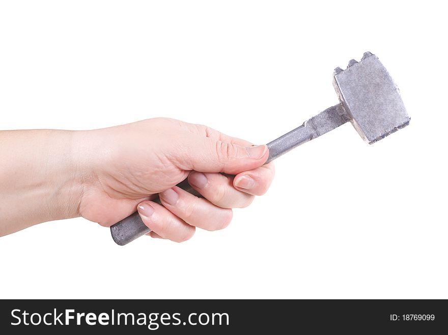 The female hand holds a metal hammer. The female hand holds a metal hammer