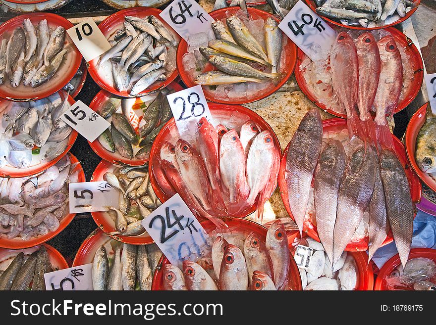 Whole fresh fishes are offered in the fish market in asia