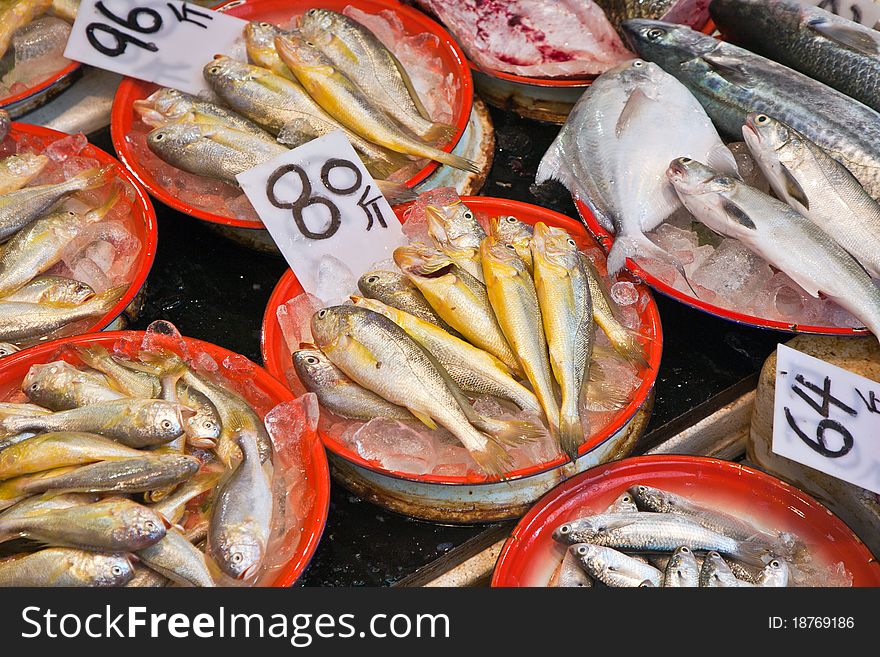 Whole fresh fishes are offered in the fish market in asia