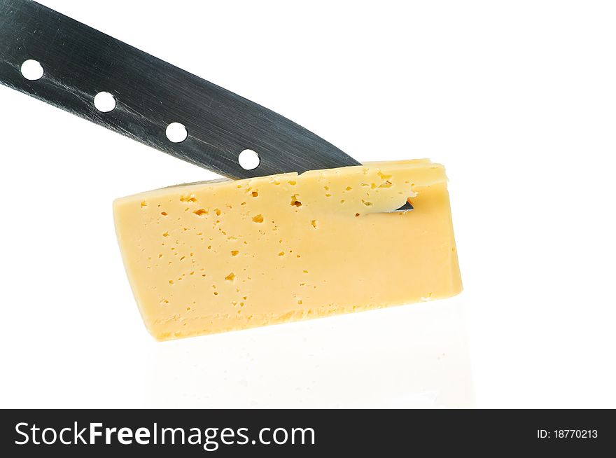 Cheese piece with knife is reflected in a white. Cheese piece with knife is reflected in a white