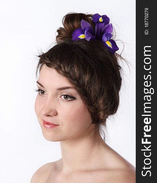 Portrait of the beauty young brunette girl with iris in her hair