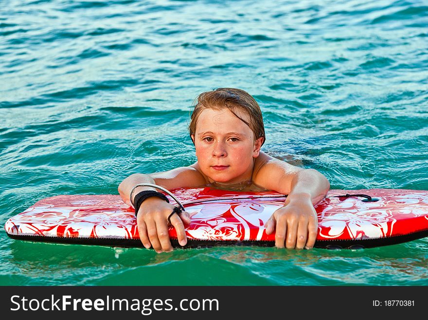 Boy exhausted from surfing