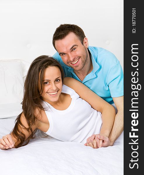 Young couple lying in white bed. Young couple lying in white bed