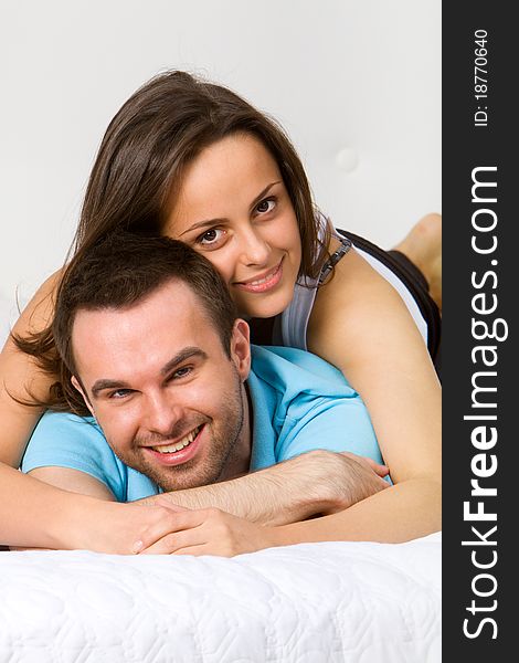 Young couple embracing in bedroom