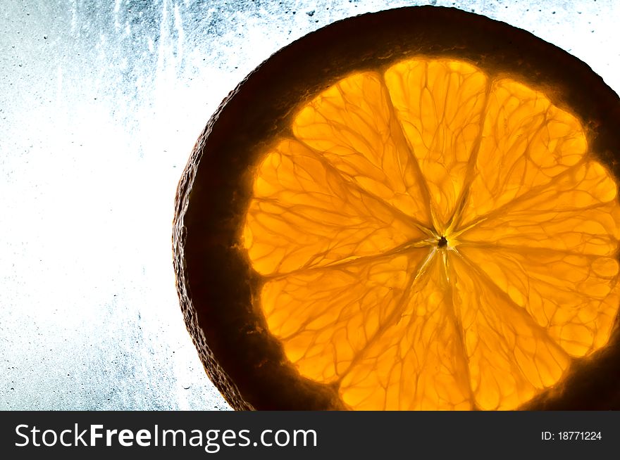 Cutted orange on wet surface
