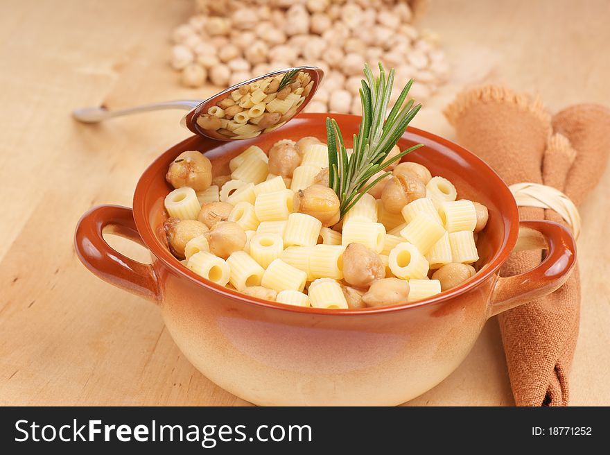 Small thimbles (ditalini) with chickpea and rosemary served in a ceramic bowl. Shallow DOF. Small thimbles (ditalini) with chickpea and rosemary served in a ceramic bowl. Shallow DOF