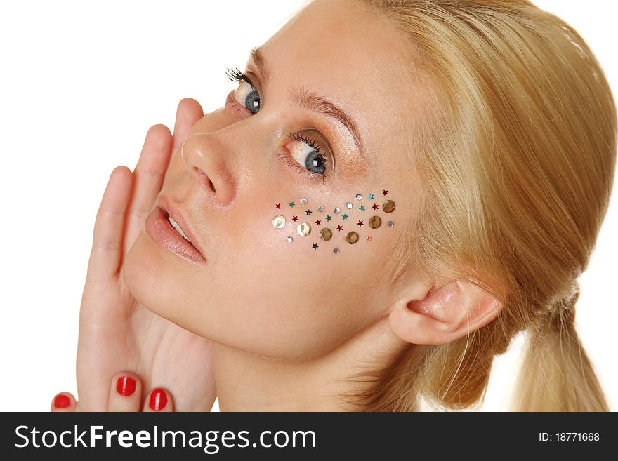 Beautiful young blond woman with makeup and multicolored crystals on the face. Beautiful young blond woman with makeup and multicolored crystals on the face