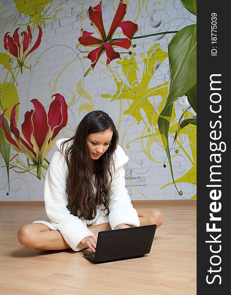 A Young Woman In A White Robe With Laptop