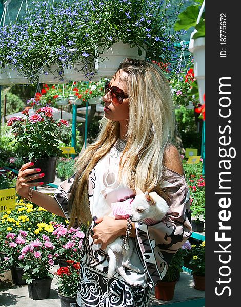 Pretty blond woman buying new plants for the garden