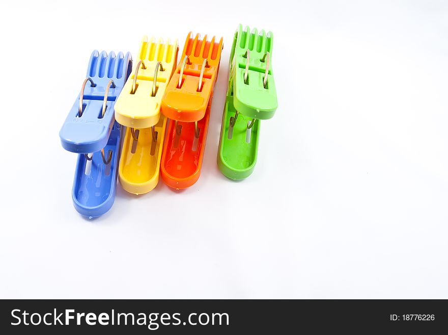 Colorful clothes pegs on white background